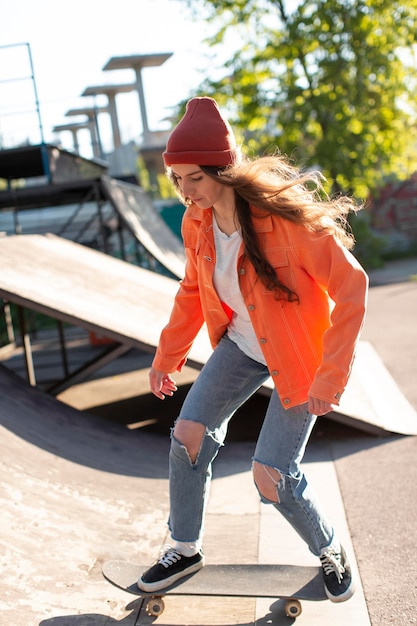 Free photo young girl skating outside  full shot