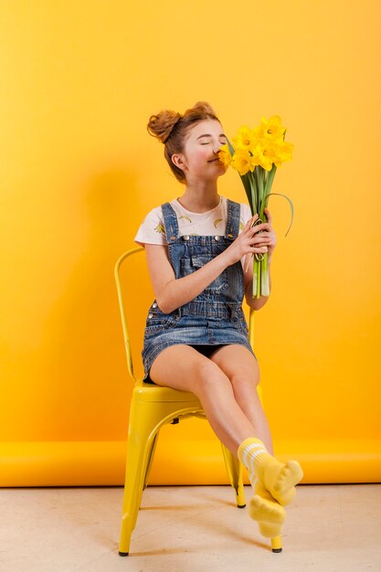 Young girl smelling flowers