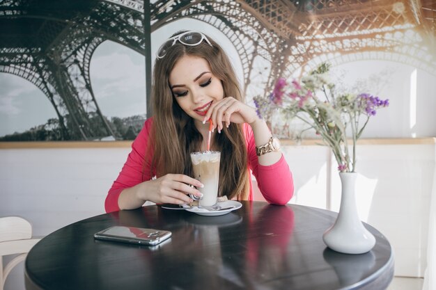 Young girl smiling drinking a chocolate milkshake