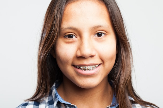 Young girl smiling with appliances on her teeth