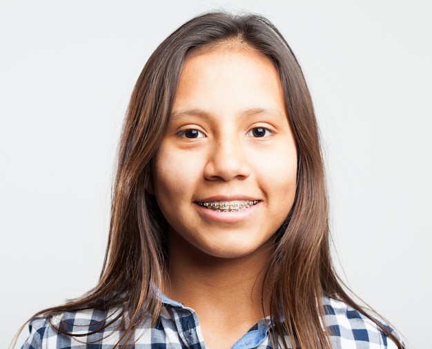 Young girl smiling with appliances on her teeth