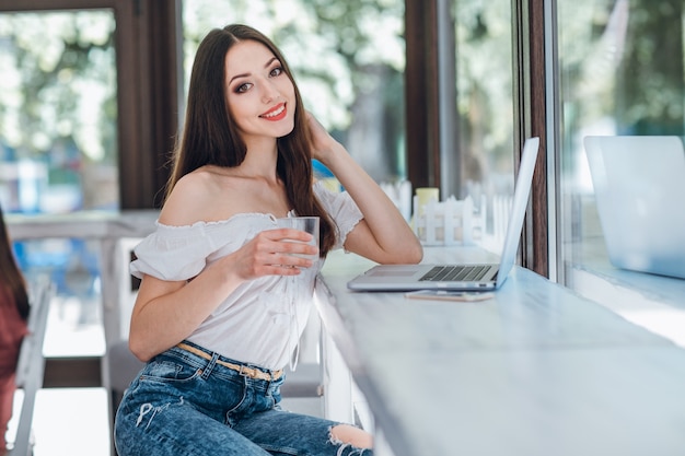 Young girl smiling with a glass in her hand