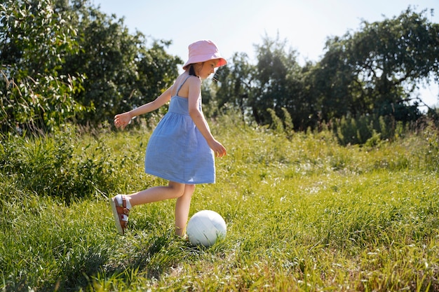 Free photo young girl spending time outdoors in a rural area enjoying childhood