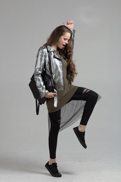 Young girl in the studio isolated on gray