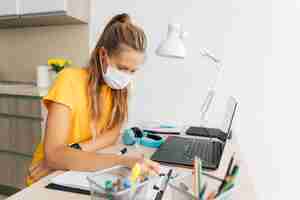 Free photo young girl studying at home