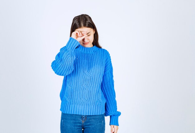 young girl in sweater feeling sick on white.