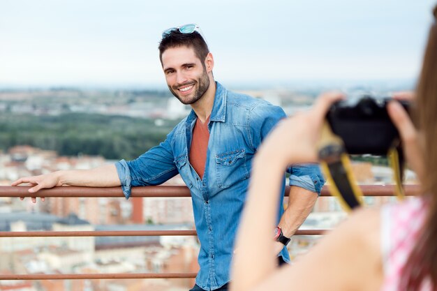 Young girl taking photo of her boyfriend.