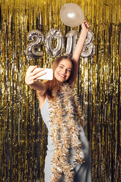 Young girl taking selfie on new year party