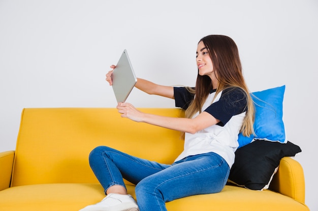 Young girl taking selfie with ipad