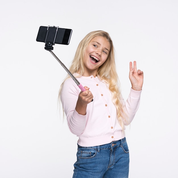 Young girl taking selfies of herself