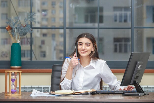 Young girl talking on the phone and smiling to the camera