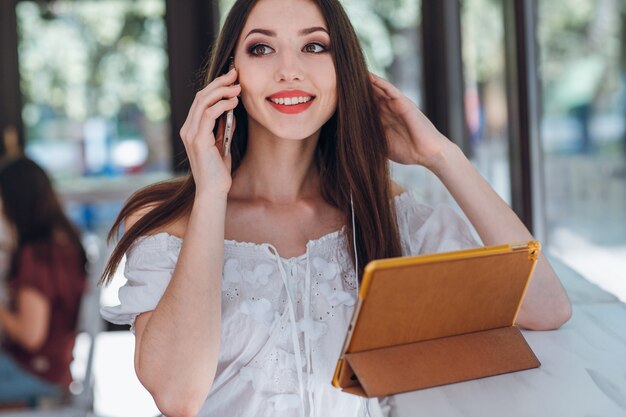 Young girl talking on the phone while smiling
