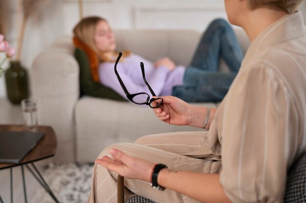 Young girl talking to therapist side view