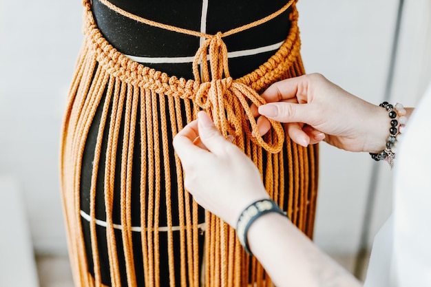 Young girl talor fitting dress on dummy