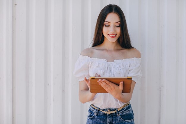 Young girl touching the screen of a tablet