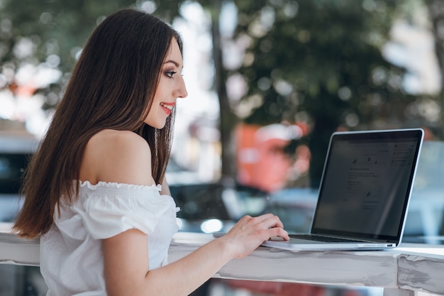 Young girl typing on a laptop