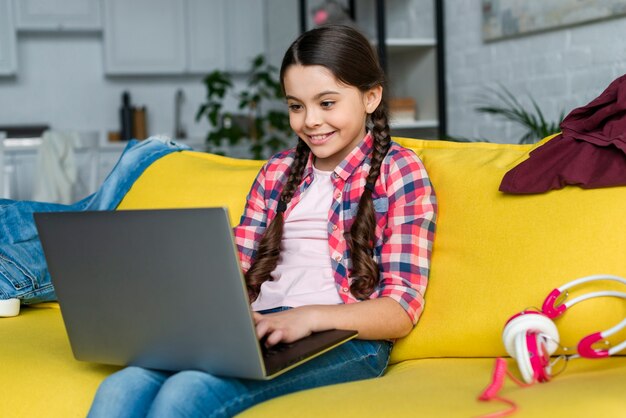 Young girl using a laptop indoors