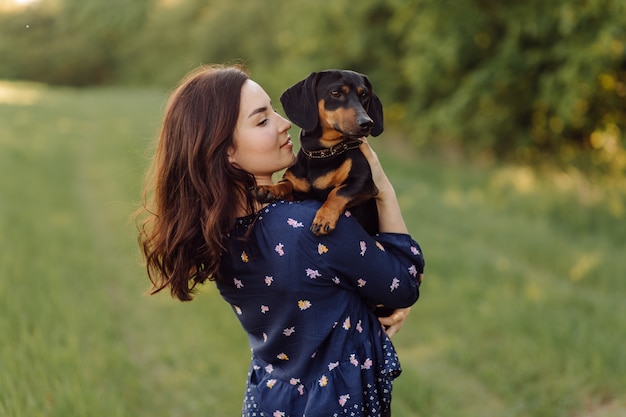 Free photo young girl on a walk with her puppy