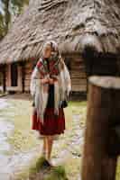 Free photo young girl walks in the village in a traditional ukrainian dress
