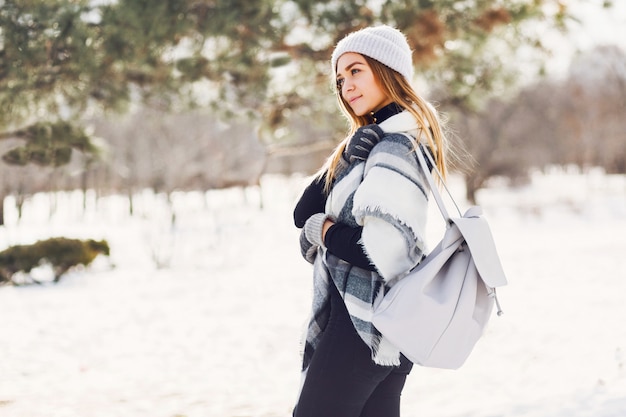 Free photo young girl wearing blanket on a snowy field