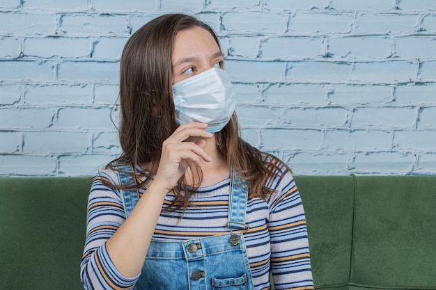 Free photo young girl wearing face mask to prevent covid virus