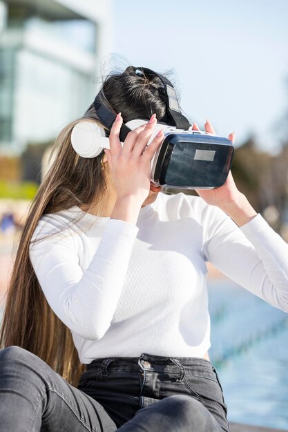 Young girl wears VR set at the park