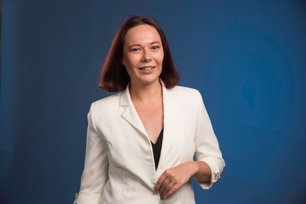 Young girl in white blazer in professional position.