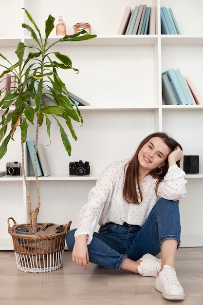 Free photo young girl in white shirt and plant