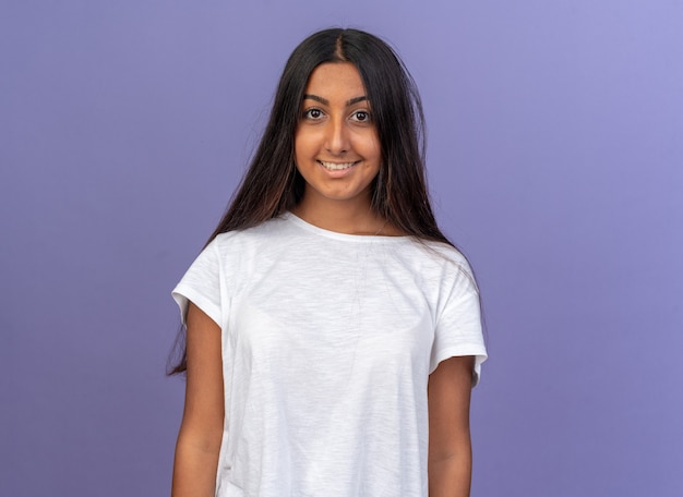 Young girl in white t-shirt looking at camera happy and cheerful smiling 