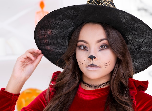 Young girl with face painted for halloween close-up