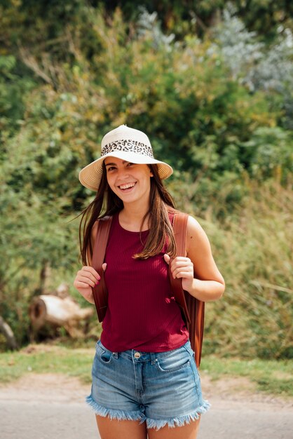 Young girl with hat smiling at the camera