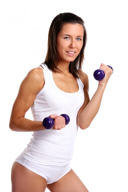 Young girl with lift weights on white