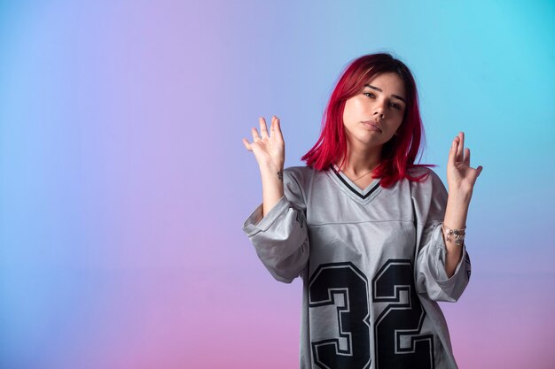 Young girl with pink hairs meditating. 