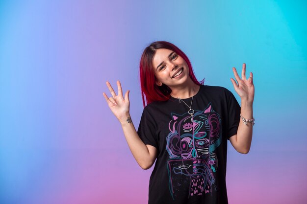 Young girl with pink hairs sending peace message.