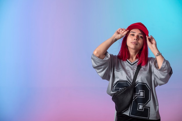 Young girl with pink hairs in street style outfits .