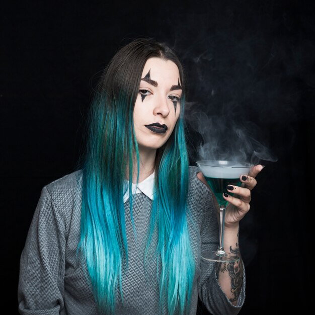 Young girl with spooky makeup and azure hair