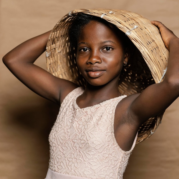 Young girl with straw basket on head