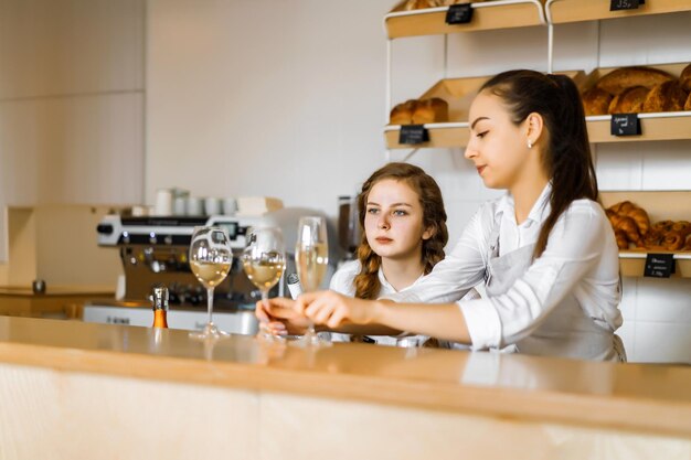 A young girl works in a cafe at the bar