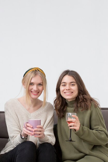 Young girlfriends drinking wine