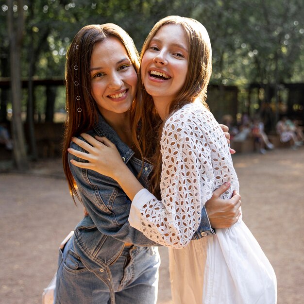 Young girlfriends hugging