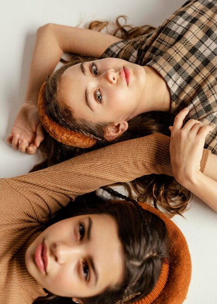 Young girlfriends laid on floor