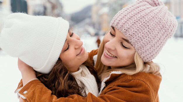 Young girlfriends outdoor looking at each other