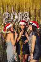 Free photo young girls drinking champagne on new year party