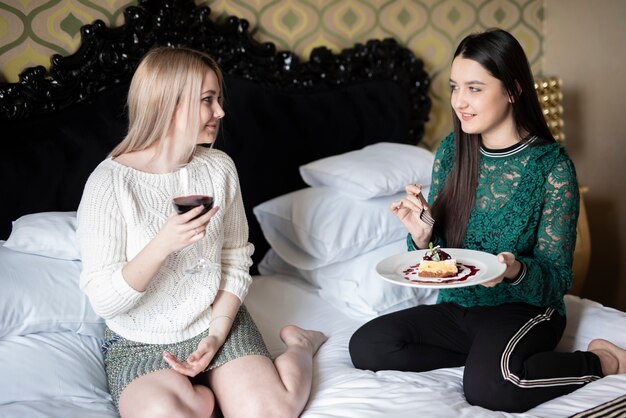 Young girls eating and drinking wine