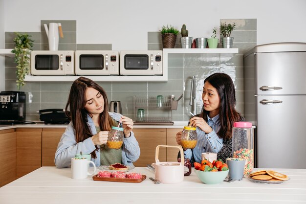 Young girls having healthy breakfast together