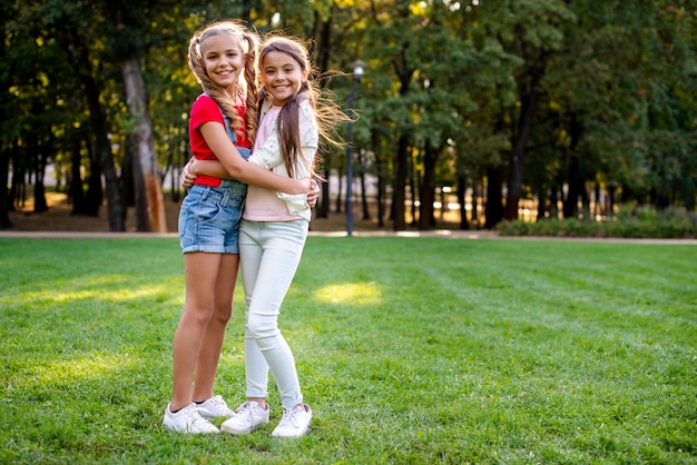 Young girls hugging copy-space