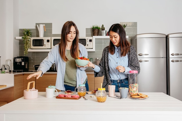 Young girls making breakfast together