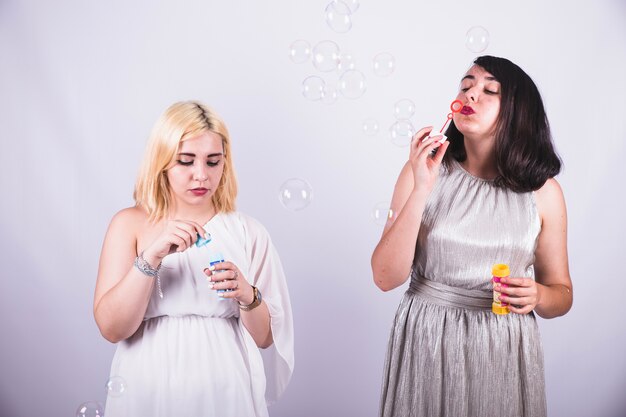 Young girls playing with bubbles