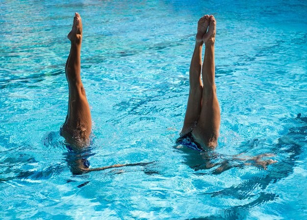 Young  girls posing inside the swimming pool