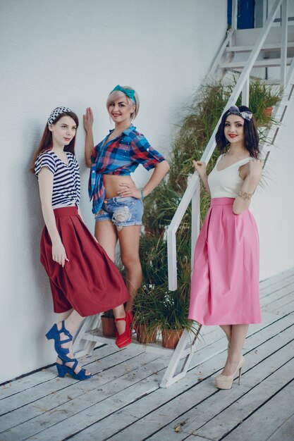 Young girls posing on stairs with plants